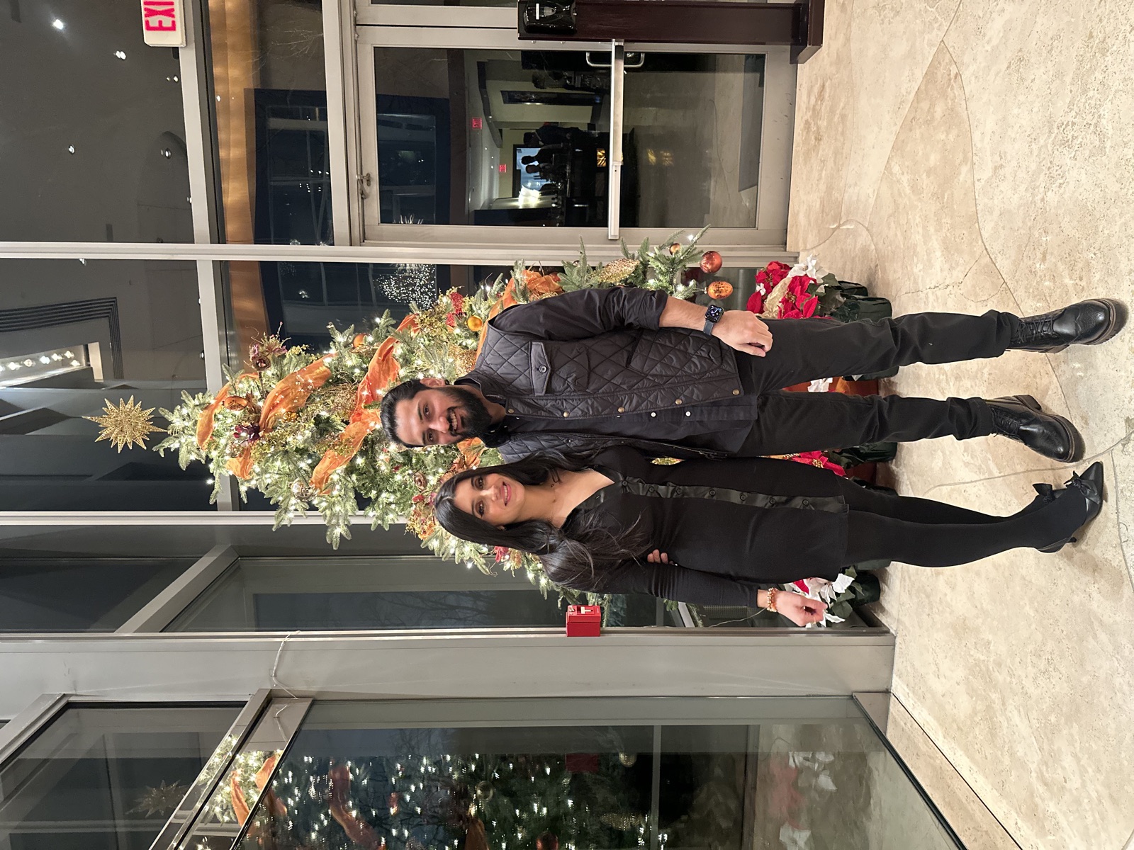 Jennifer and Samir by the Christmas tree